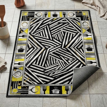 Black and white dazzle stripe kitchen mat with gold accents and kitchen utensil silhouette border
