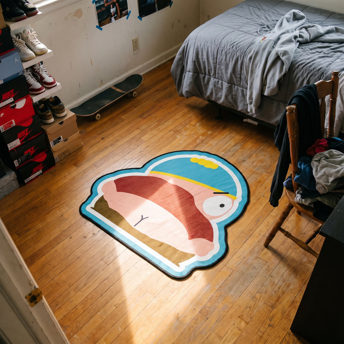 Top-down shot of the Eric Cartman shaped rug next to a desk setup