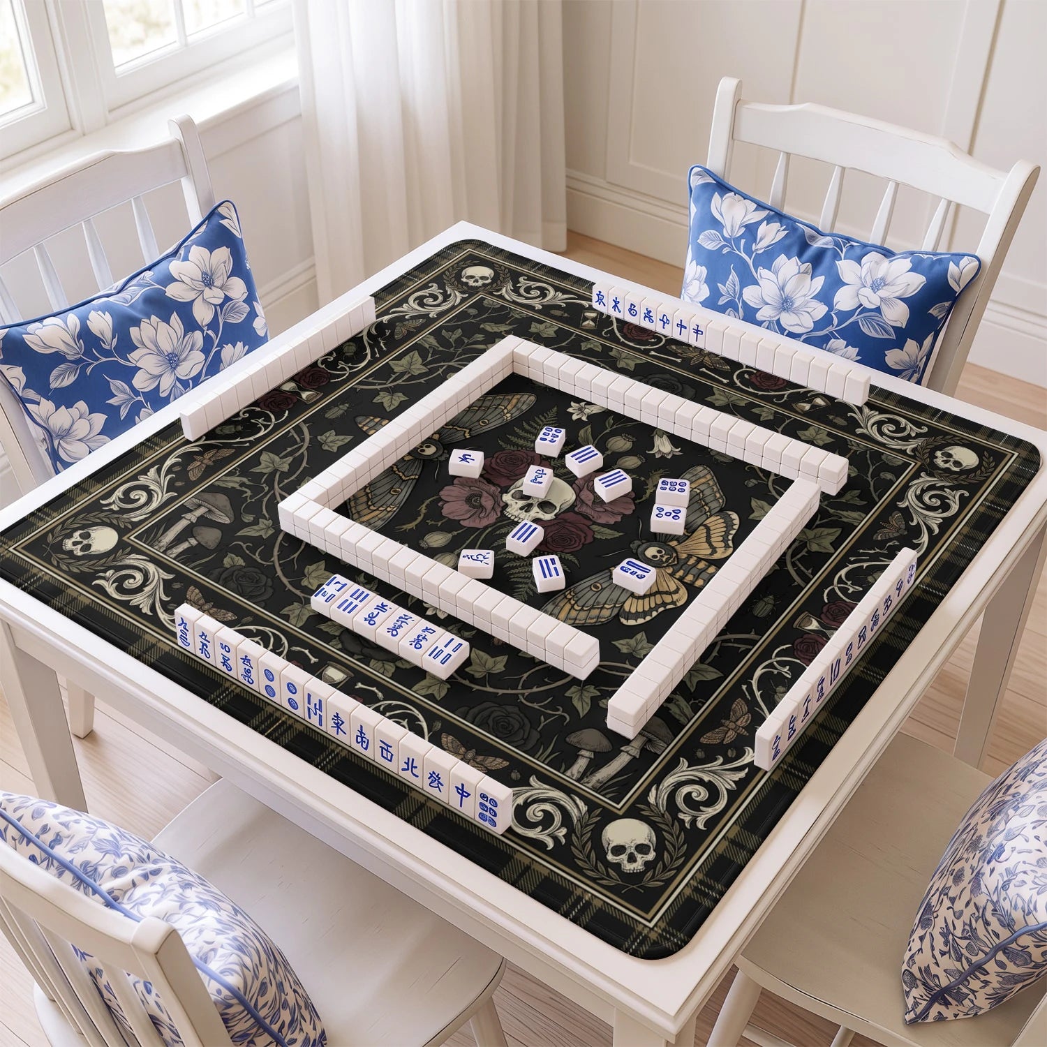 Gothic Moth Skull mahjong mat with tiles and racks on the table