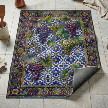 Purple and green grape clusters kitchen mat on blue azulejo tile with plum and gold vine border