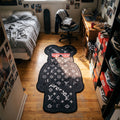 LV Bearbrick shaped area rug in a bedroom with sneakers and a skateboard