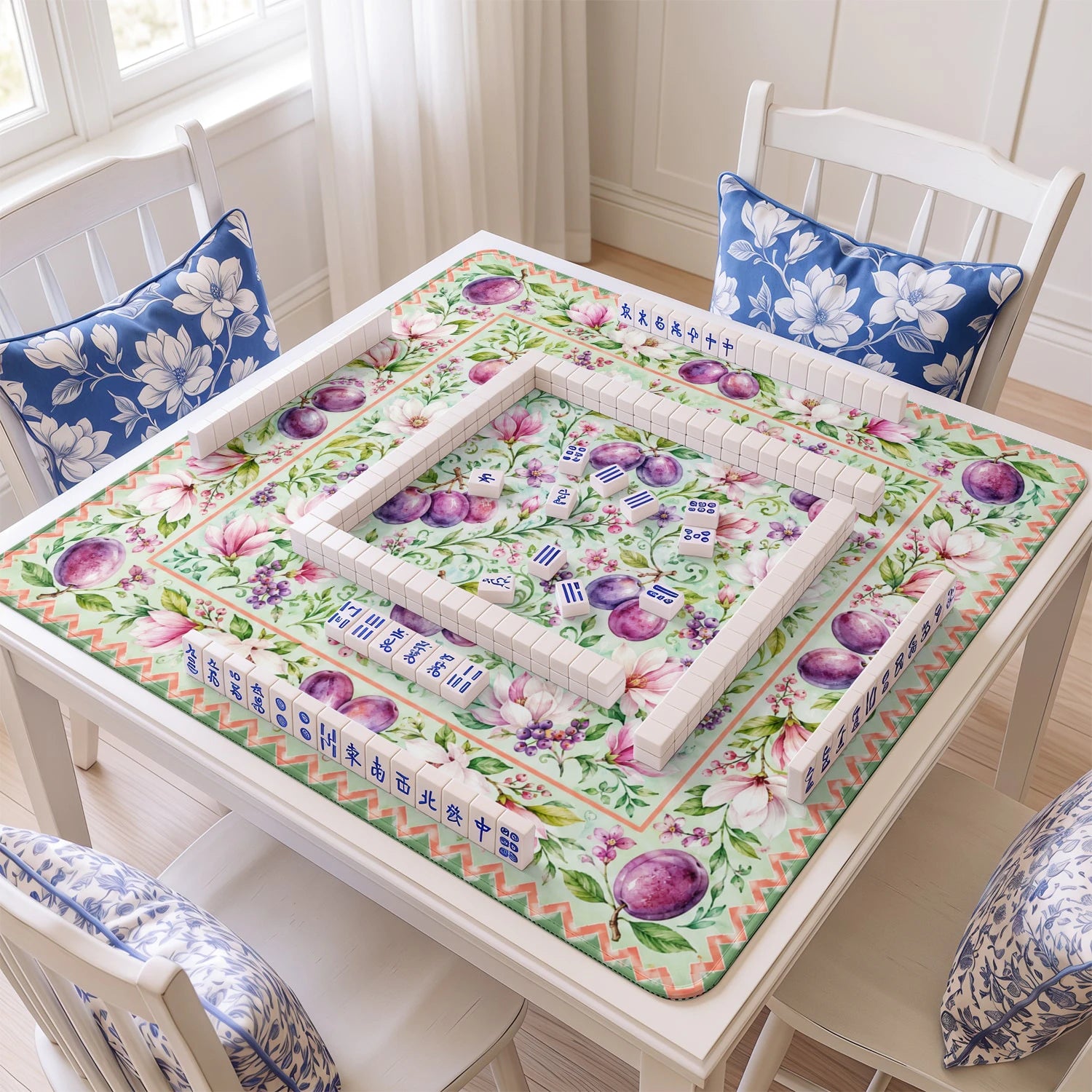 Plum Magnolia mahjong mat with tiles and racks on the table