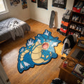 Roaring Gyarados shaped rug on wood flooring beside a bed