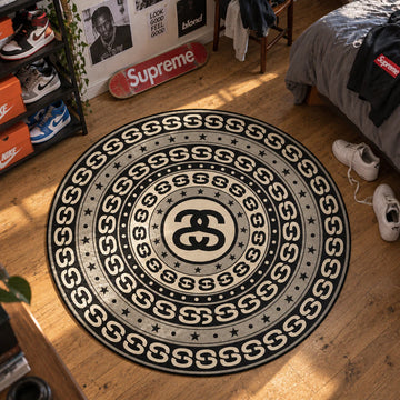 Stussy Medallion hypebeast round rug on a bedroom floor - hypebeast chair mat