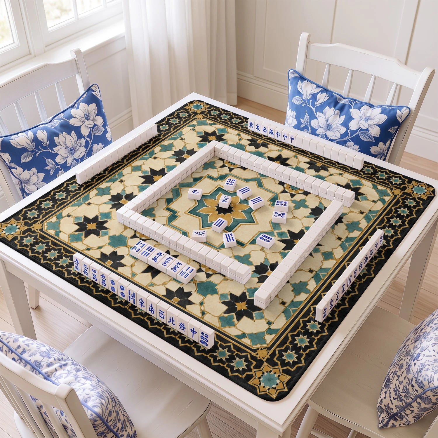 Teal Moroccan Star mahjong mat with tiles and racks on the table